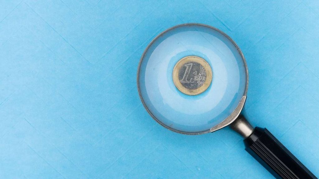 1 euro con una lente d'ingrandimento