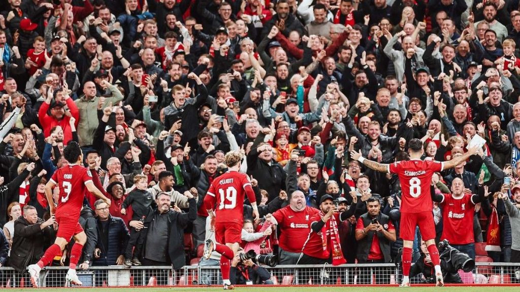 I giocatori esultano sotto la Kop, la celebre curva del Liverpool
