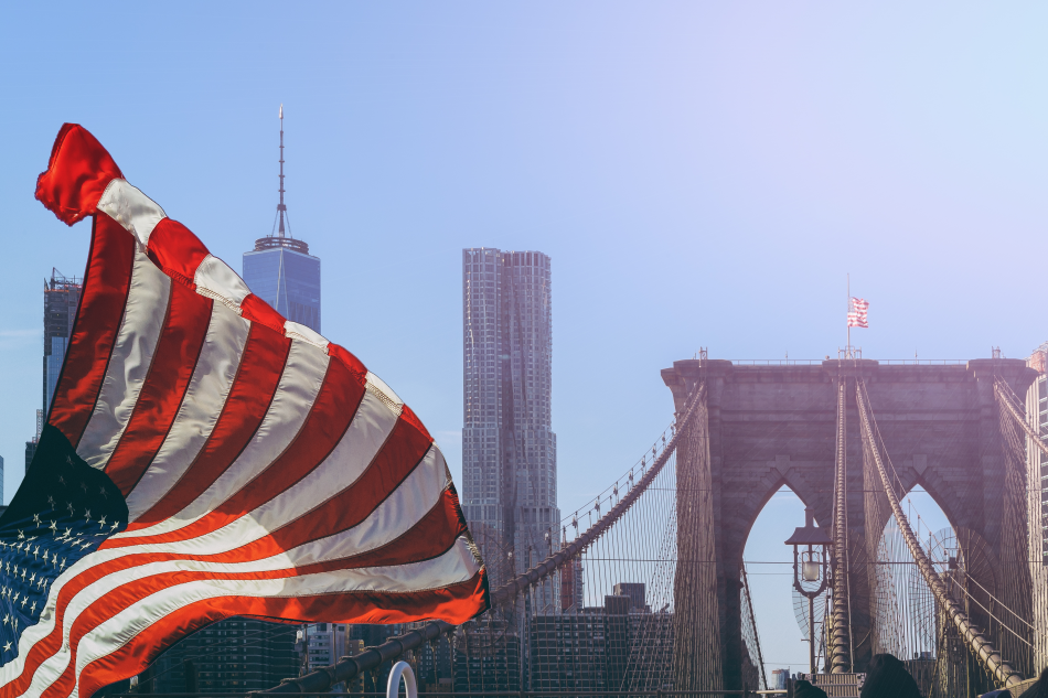 La bandiera degli USA sventola davanti al ponte di Brooklin
