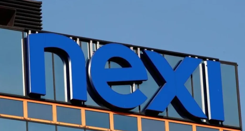Logo di Nexi su una facciata di vetro di un edificio moderno, simbolo di una delle principali aziende europee nel settore dei pagamenti digitali.