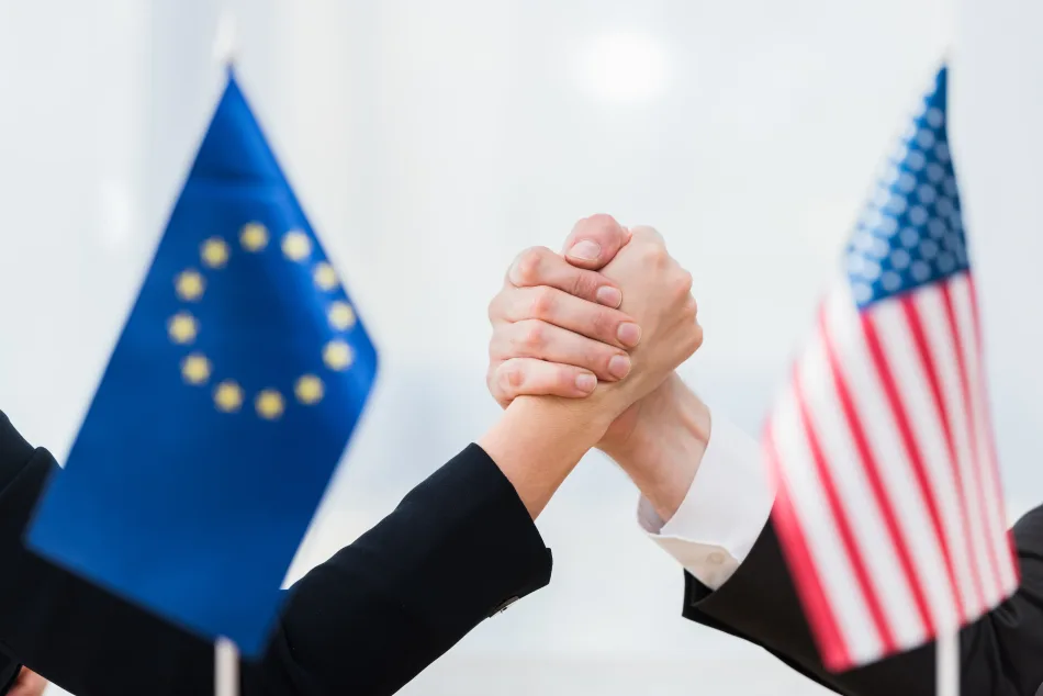 Un braccio di ferro tra rappresentanti di Europa e Stati Uniti, come indicato dalle rispettive bandierine