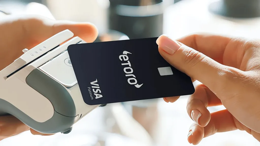 Una donna usa la carta di debito di eToro