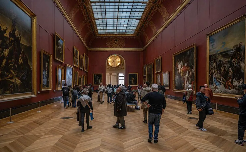 Una sala del Louvre affollata di visitatori