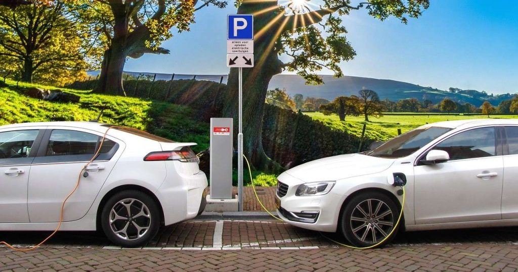 Immagine di due auto elettriche in ricarica in una stazione