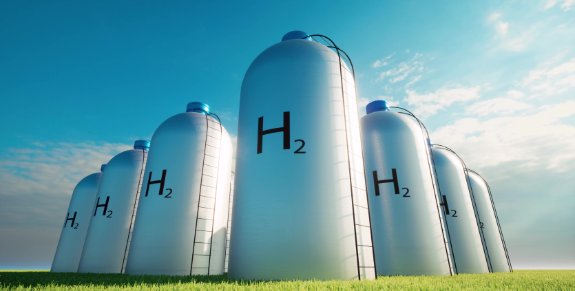 Un concept che rappresenta una serie di silos per la raccolta dell'idrogeno, in un campo di erba verde