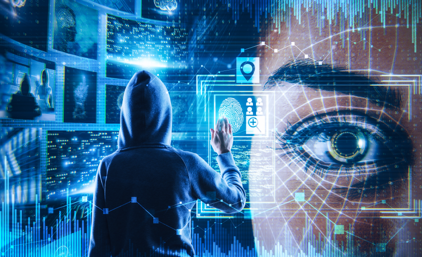 Immagine costruita al pc: mostra un uomo incappucciato di spalle davanti a dei circuiti elettronici mentre in primo piano, sulla parte destra, l'occhio di una bella ragazza spia.