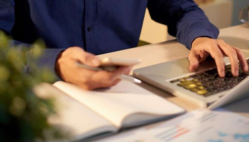 Un solopreneur cinese dell'Ai lavora tra computer e smartphone