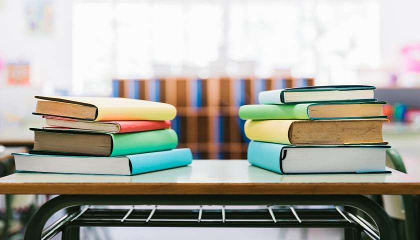 Grafica blu e oro con libri, zaino e simboli scolastici dedicata al Bonus scuola 2026/2027