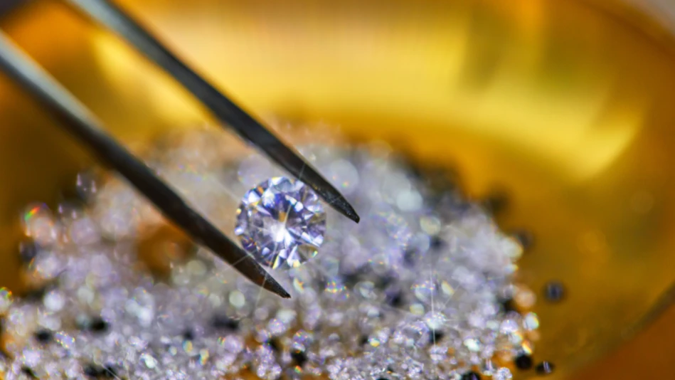 Un diamante viene selezionato con una pinzetta da un gruppo di altre pietre preziose