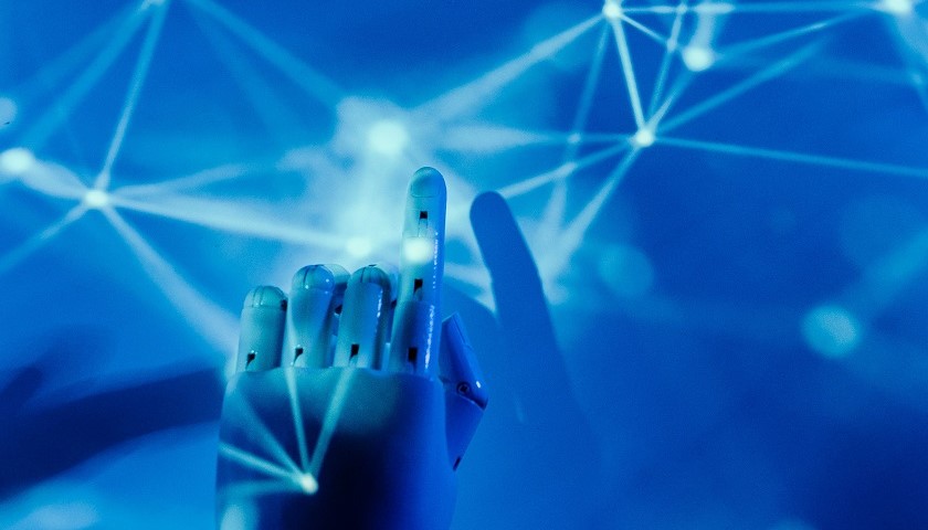 La mano di un robot umanoide su uno sfondo digitale
